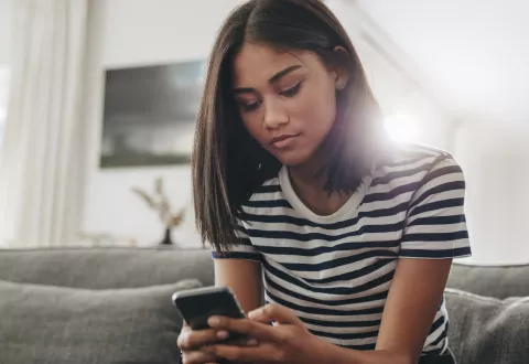 young girl looking at phone